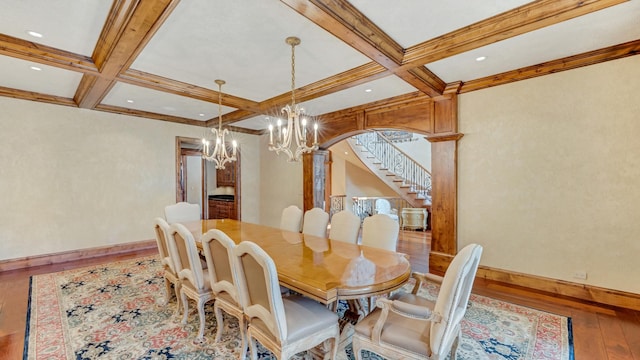 dining space with beamed ceiling, arched walkways, coffered ceiling, and wood-type flooring