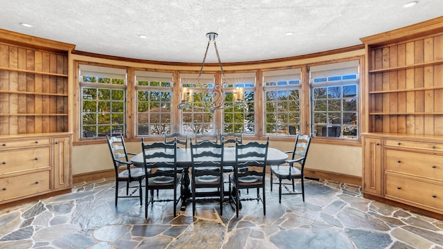 dining room featuring baseboards, a textured ceiling, stone flooring, and crown molding