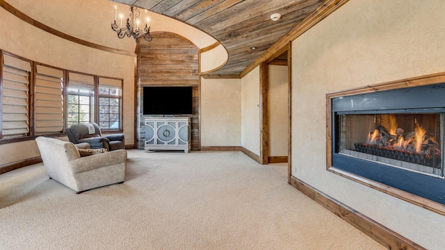 living room with carpet floors, a high ceiling, a warm lit fireplace, wooden ceiling, and a chandelier