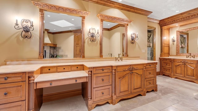 full bath with vanity, crown molding, and a skylight