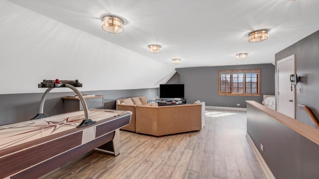 office with lofted ceiling, baseboards, and light wood finished floors