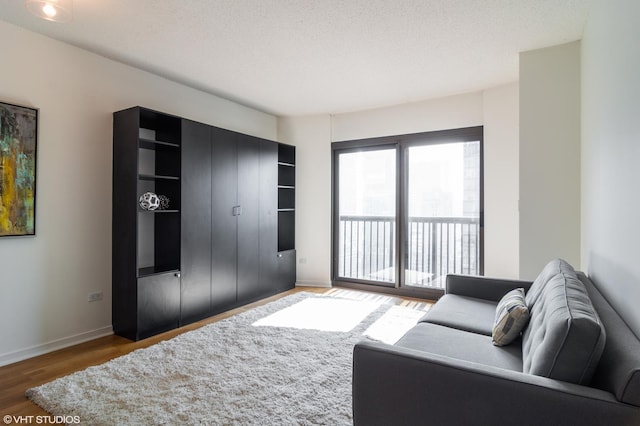 living room with dark hardwood / wood-style floors and a textured ceiling