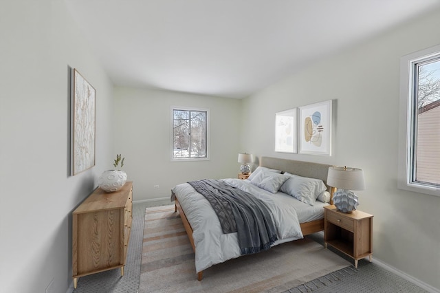 carpeted bedroom featuring baseboards