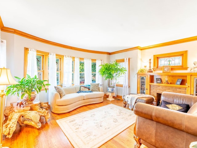 living room featuring crown molding, a brick fireplace, and hardwood / wood-style flooring