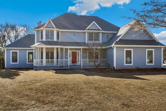 view of front of house with covered porch and a front lawn