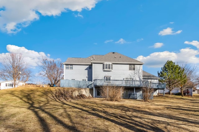 back of house with a yard and a deck