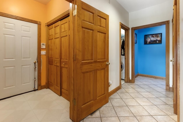 entrance foyer with stacked washer and dryer