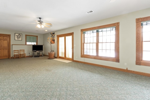 unfurnished living room with carpet and ceiling fan