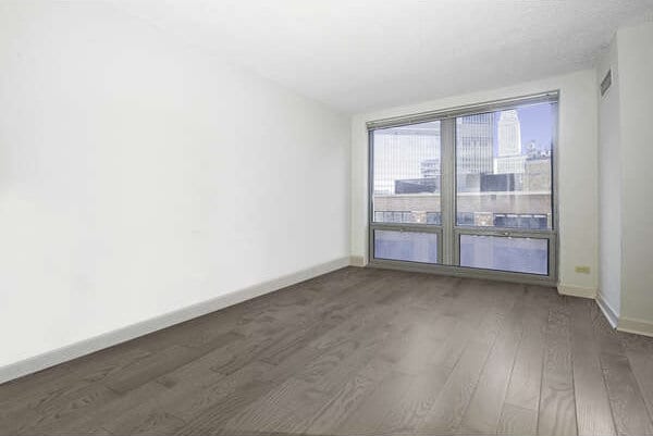 440 N Wabash Ave Unit 1007, Chicago, IL 60611 - spare room featuring dark wood-style floors and baseboards
