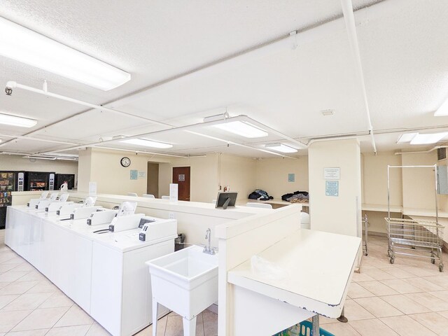 440 N Wabash Ave Unit 1007, Chicago, IL 60611 - common laundry area with light tile patterned floors, separate washer and dryer, and a sink