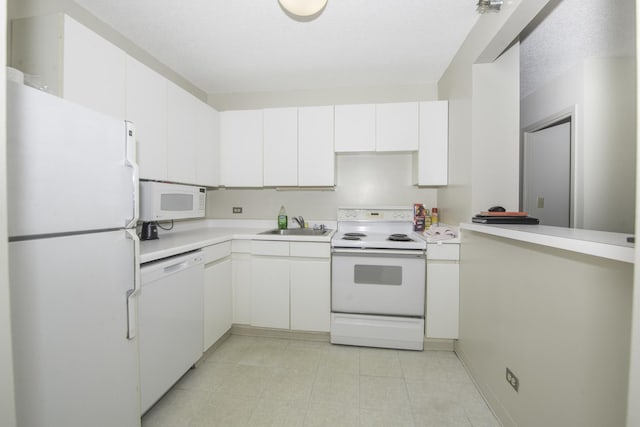 440 N Wabash Ave Unit 1007, Chicago, IL 60611 - kitchen with light countertops, white cabinets, a sink, white appliances, and a peninsula