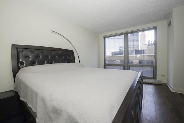 440 N Wabash Ave Unit 1007, Chicago, IL 60611 - bedroom with dark wood-type flooring, a textured ceiling, and baseboards