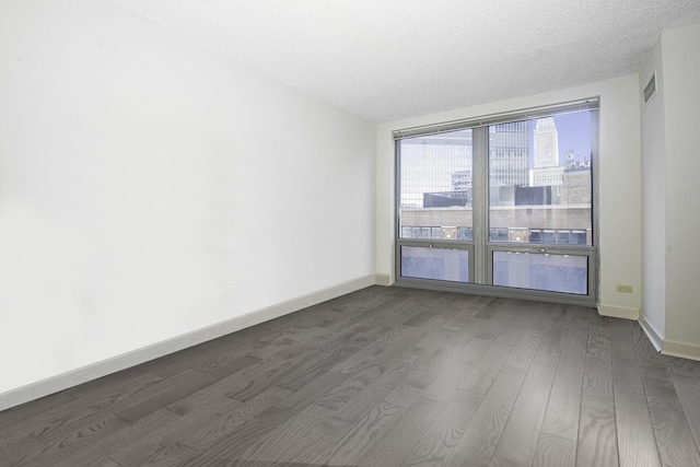440 N Wabash Ave Unit 1007, Chicago, IL 60611 - spare room with a view of city, dark wood finished floors, a textured ceiling, and baseboards