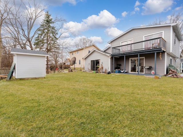 back of property featuring a storage shed, a patio area, and a lawn