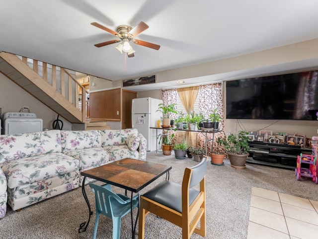 living room with light tile patterned flooring, ceiling fan, and washer / clothes dryer