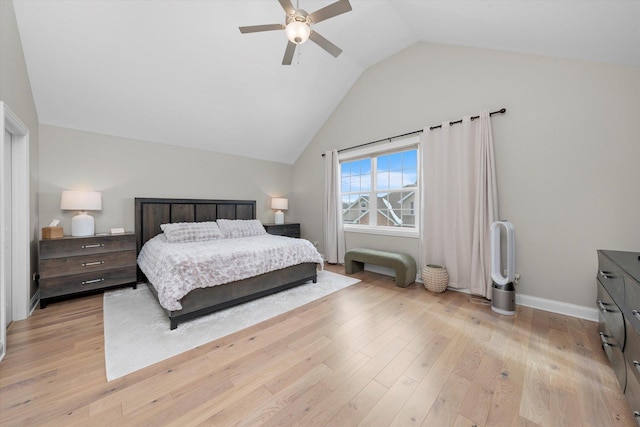 bedroom with vaulted ceiling, baseboards, light wood-style flooring, and a ceiling fan