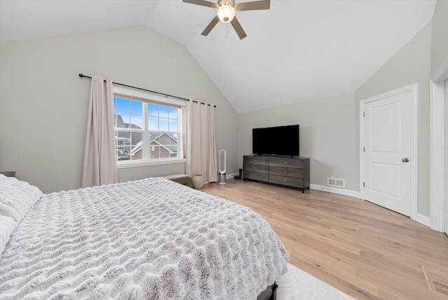 bedroom with a ceiling fan, visible vents, vaulted ceiling, baseboards, and light wood finished floors