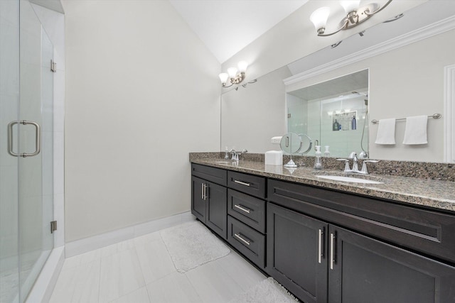 bathroom with vaulted ceiling, double vanity, a sink, and a shower stall