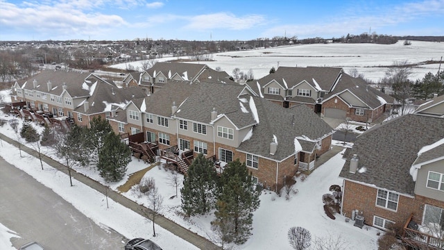 snowy aerial view with a residential view