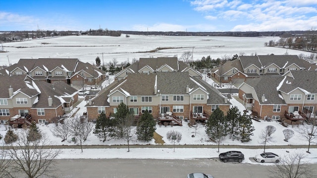 snowy aerial view featuring a residential view