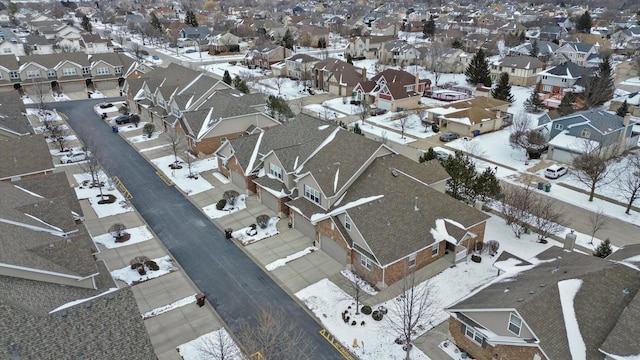 snowy aerial view featuring a residential view