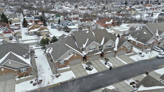 snowy aerial view with a residential view