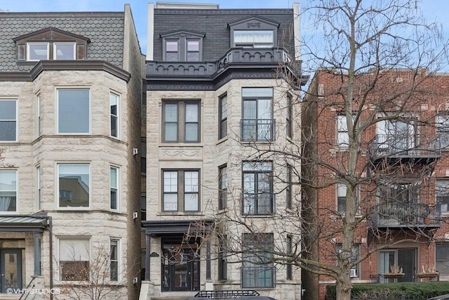 view of front of home featuring mansard roof