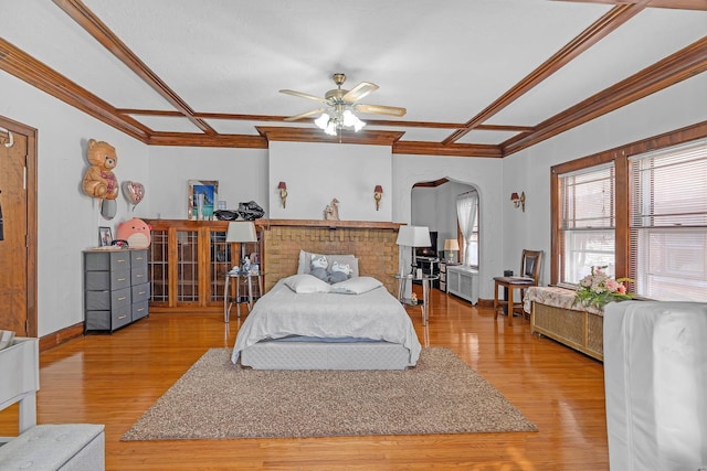 bedroom featuring crown molding, coffered ceiling, and wood finished floors