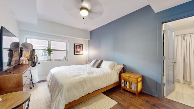 bedroom with dark wood-type flooring and ceiling fan