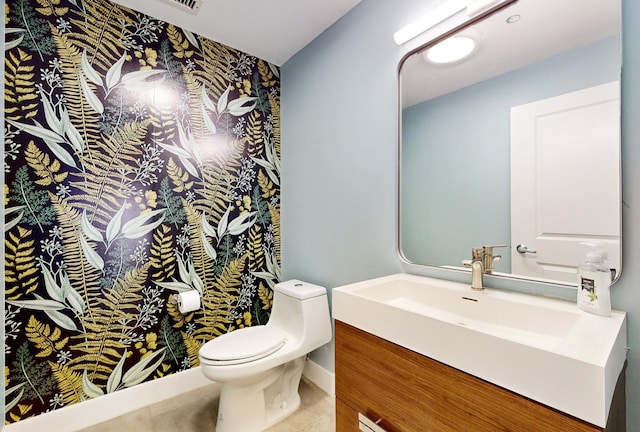 bathroom with tile patterned flooring, vanity, and toilet