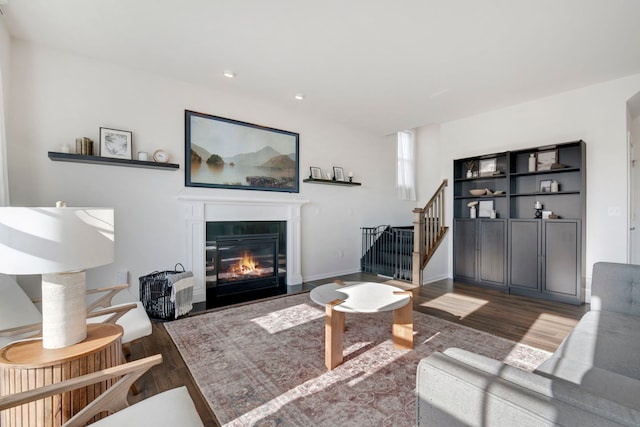 885 Simpson Ave, Elburn, IL 60119 - living area featuring wood finished floors, a glass covered fireplace, stairs, and recessed lighting
