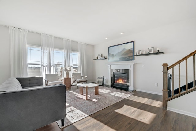 885 Simpson Ave, Elburn, IL 60119 - living area featuring a glass covered fireplace, wood finished floors, stairs, and baseboards