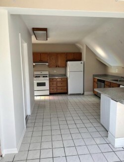 420 N Marion St, Oak Park, IL 60302 - kitchen with white appliances, lofted ceiling, brown cabinets, extractor fan, and light tile patterned flooring