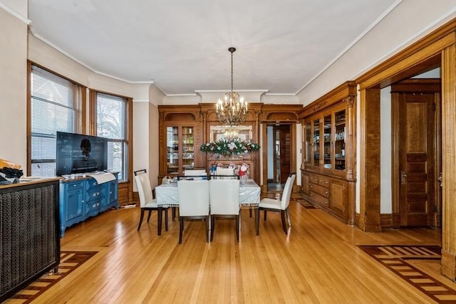 420 N Marion St, Oak Park, IL 60302 - dining area with a chandelier, light wood finished floors, and ornamental molding