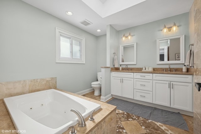 bathroom featuring double vanity, visible vents, toilet, a sink, and a tub with jets