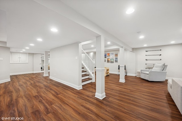 finished below grade area with baseboards, stairway, dark wood-style flooring, and recessed lighting