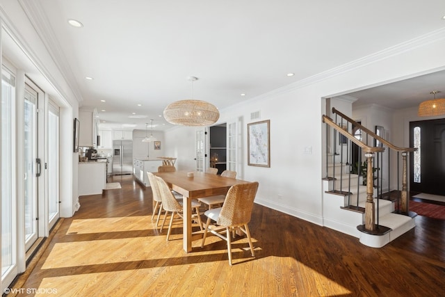 dining room featuring crown molding, recessed lighting, visible vents, light wood-type flooring, and stairs