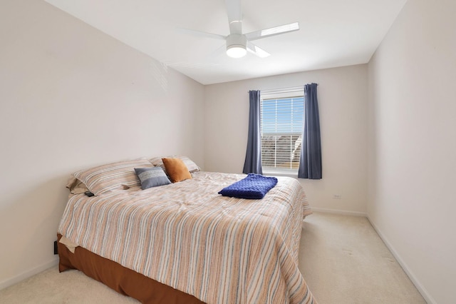 bedroom featuring light carpet, ceiling fan, and baseboards