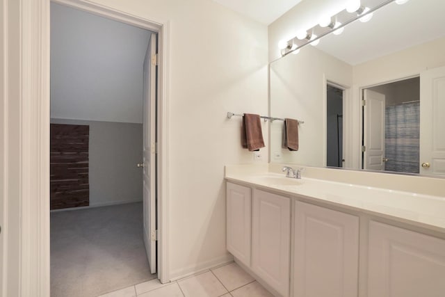 full bath featuring tile patterned flooring, baseboards, and vanity