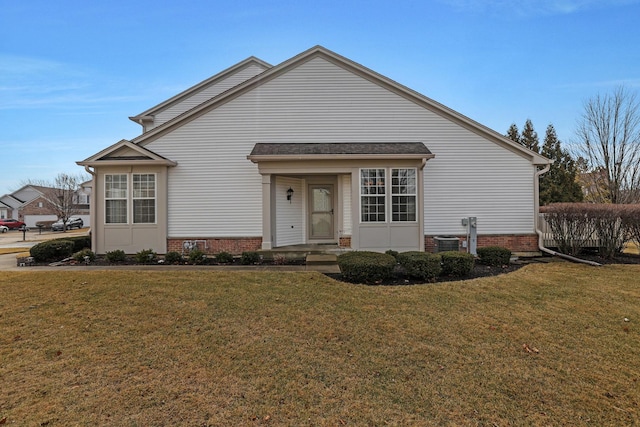 view of front of property featuring central AC and a front yard