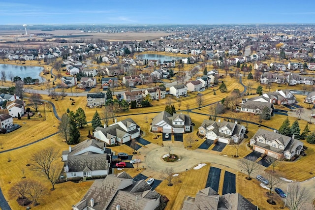 birds eye view of property with a water view and a residential view