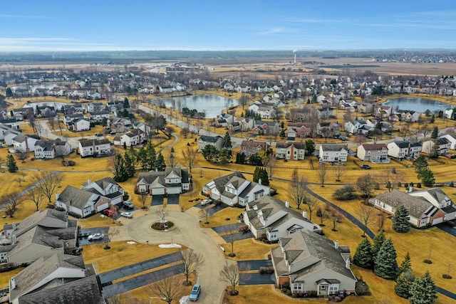 birds eye view of property featuring a water view and a residential view