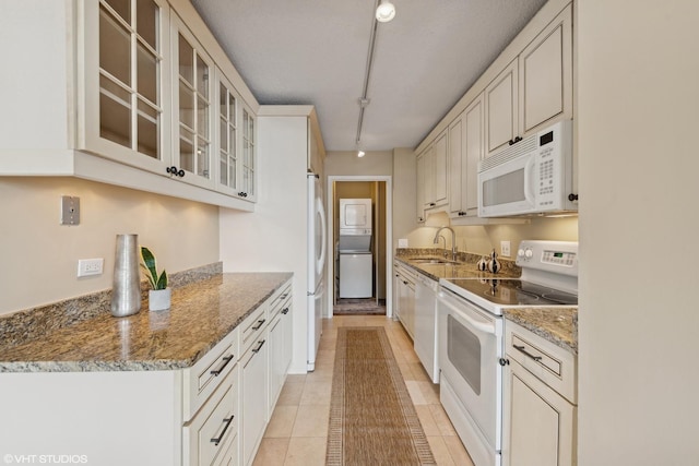 kitchen featuring sink, white appliances, white cabinets, and stone counters