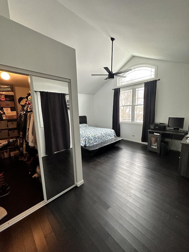 bedroom with dark hardwood / wood-style flooring, ceiling fan, a closet, and lofted ceiling