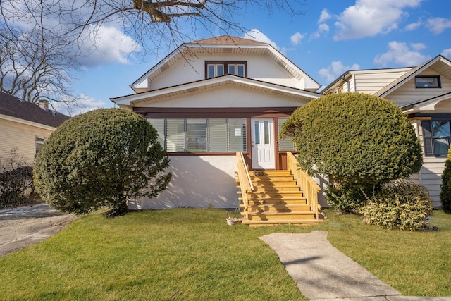 bungalow-style house with a front yard