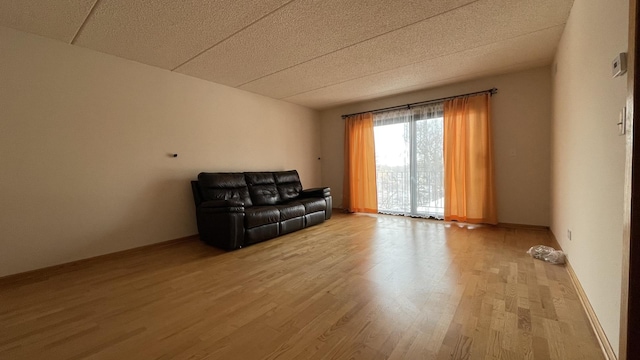 unfurnished room with baseboards and wood finished floors