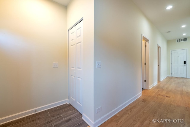 hallway with wood-type flooring