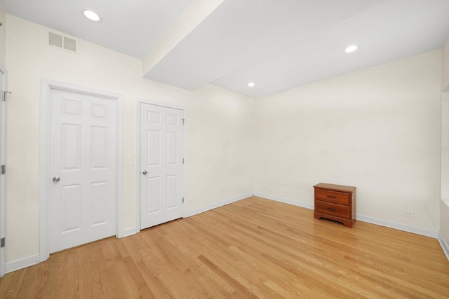 unfurnished bedroom with light wood finished floors, recessed lighting, visible vents, and baseboards