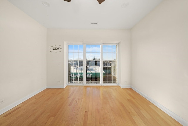 unfurnished room featuring light wood-type flooring, ceiling fan, and baseboards