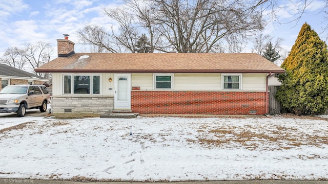 view of front of property with brick siding, a chimney, a shingled roof, crawl space, and stone siding